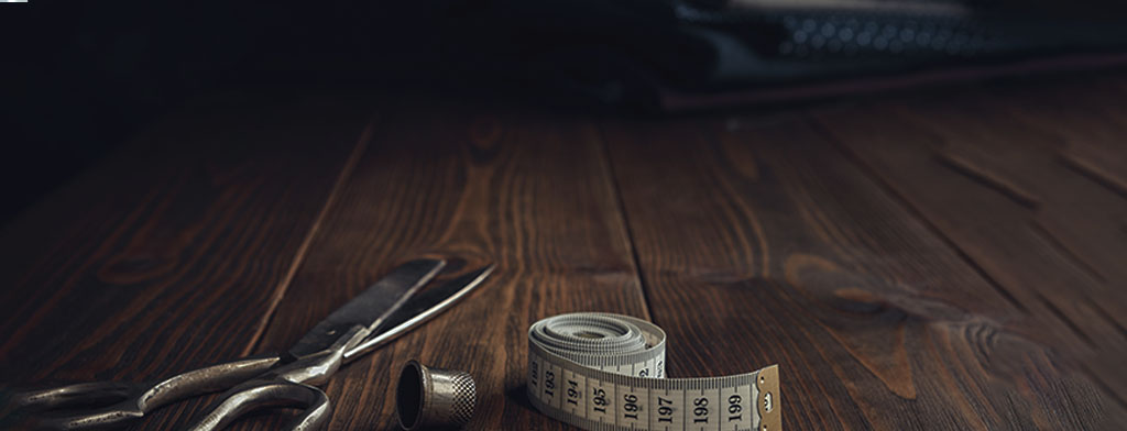 Fashion Localization Image showcasing scissors and a measurement tape on a table